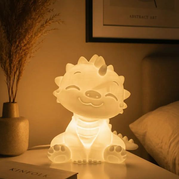 Cute dinosaur-shaped night light on a bedside table with a warm glow.