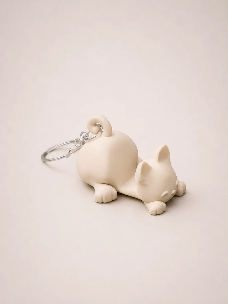 White dog-shaped keychain on a beige background
